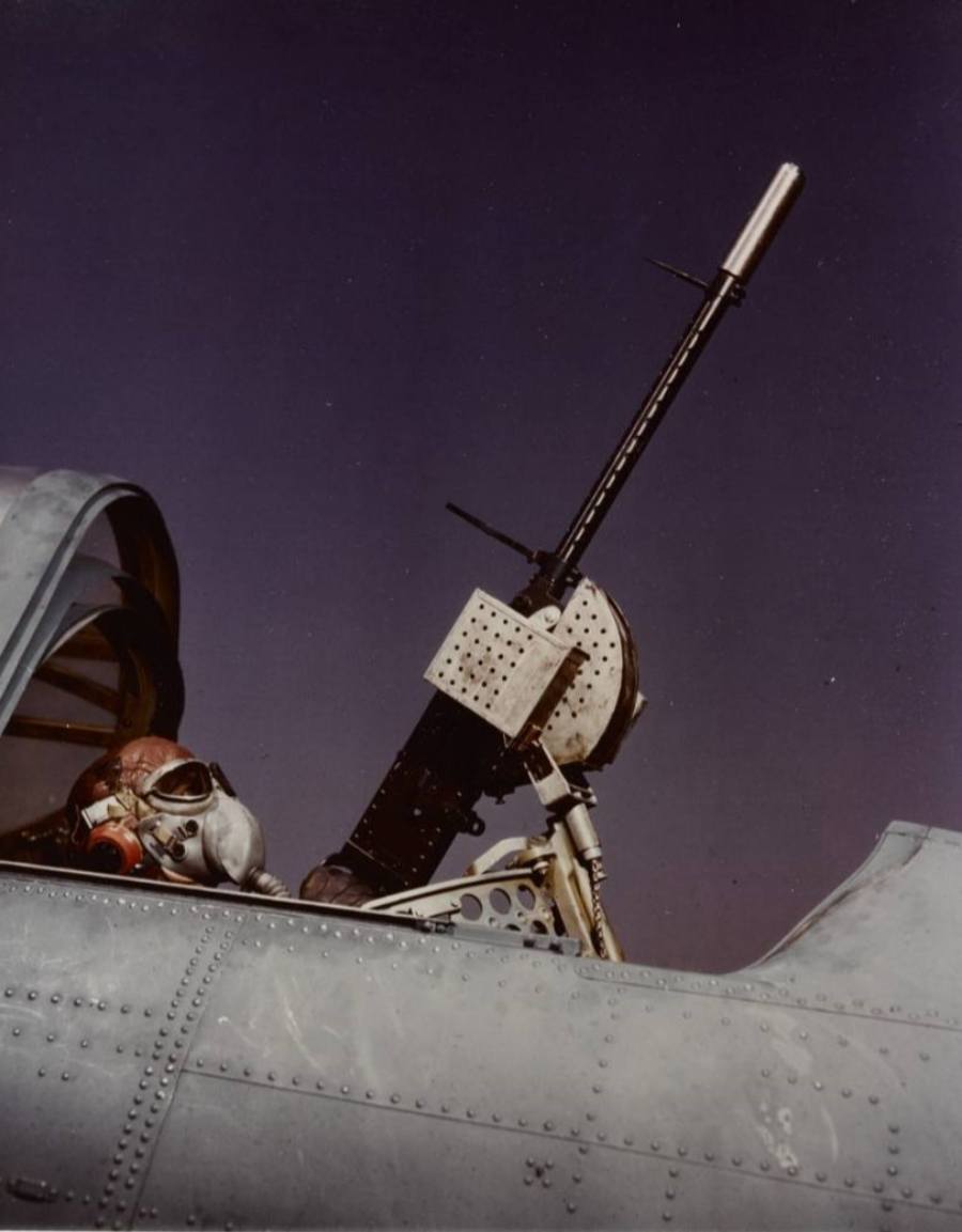 Under the rear cockpit of a Dauntless aircraft, a gunner in an oxygen mask with a .30 caliber machine gun in 1941–1943. (Credit: National Archives)