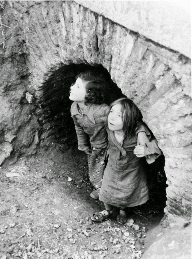 Children take refuge during the Francoist bombing over Madrid (1936–1937). 