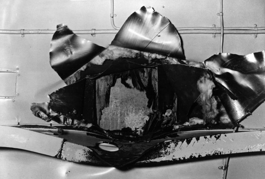 The large hole caused by the Japanese bomb that hit the USS Yorktown on May 8, 1942, during the Battle of the Coral Sea, as seen from below the ship's flight deck structure. (Image: Naval History and Heritage Command)