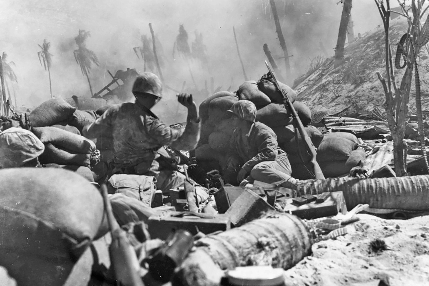 A Marine throws a grenade during the fight for Betio Island in Tarawa, ca. November 1943.