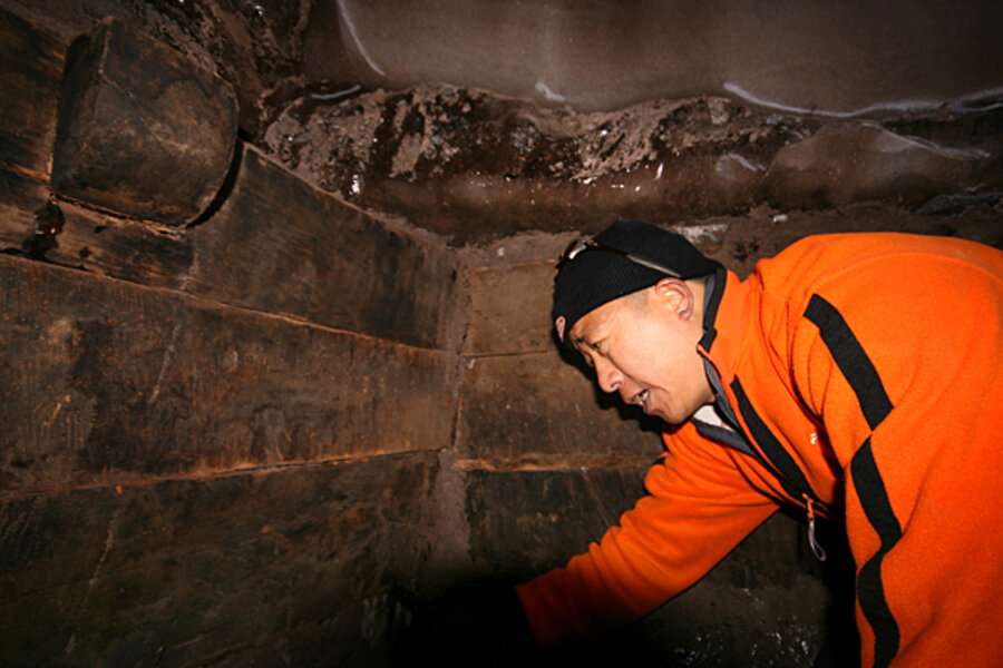 An explorer examines wooden beams inside what some are nearly certain is the remains of Noah's Ark.  