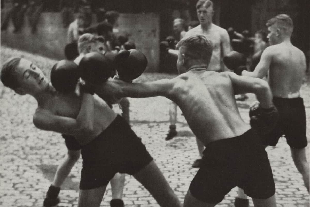 Boxing by members of the 1937 Hitler Youth program. In 1922, the Hitler Youth program was established to indoctrinate German youth with Nazi ideology and train them for a future as the master race.