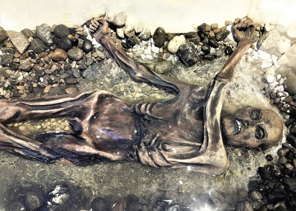 A lifelike Ötzi, the glacier man replica is on display.