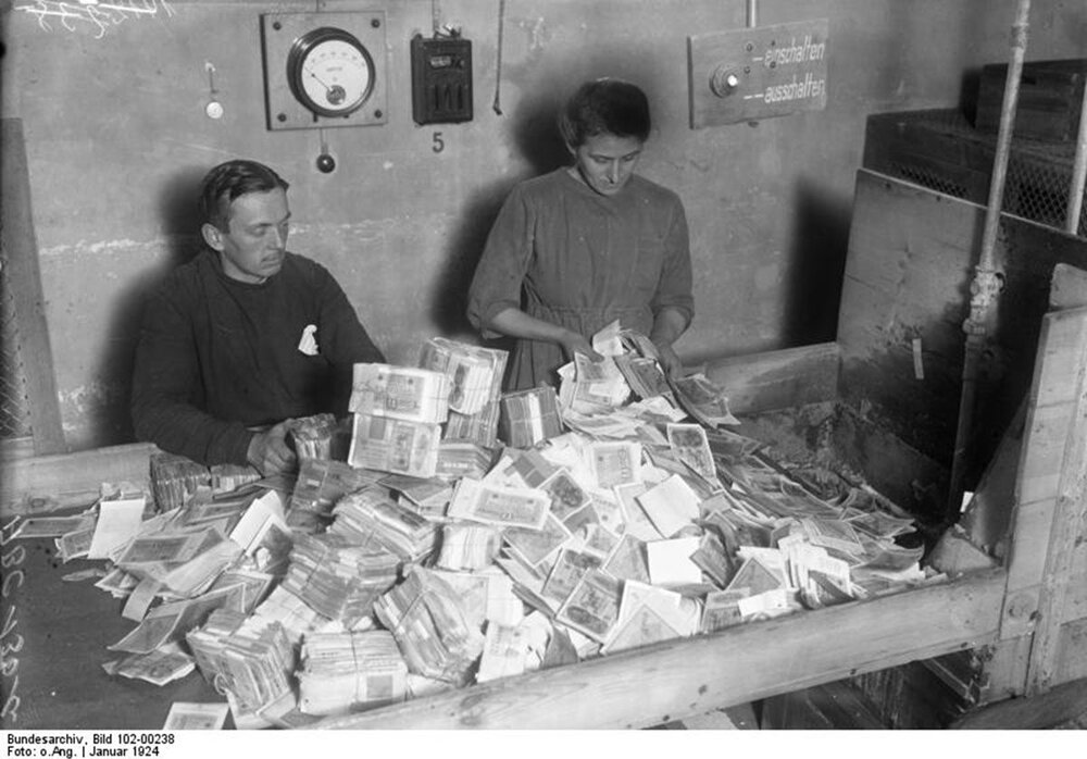 Germans burning their worthless money in the economic crisis during the Weimar Republic.