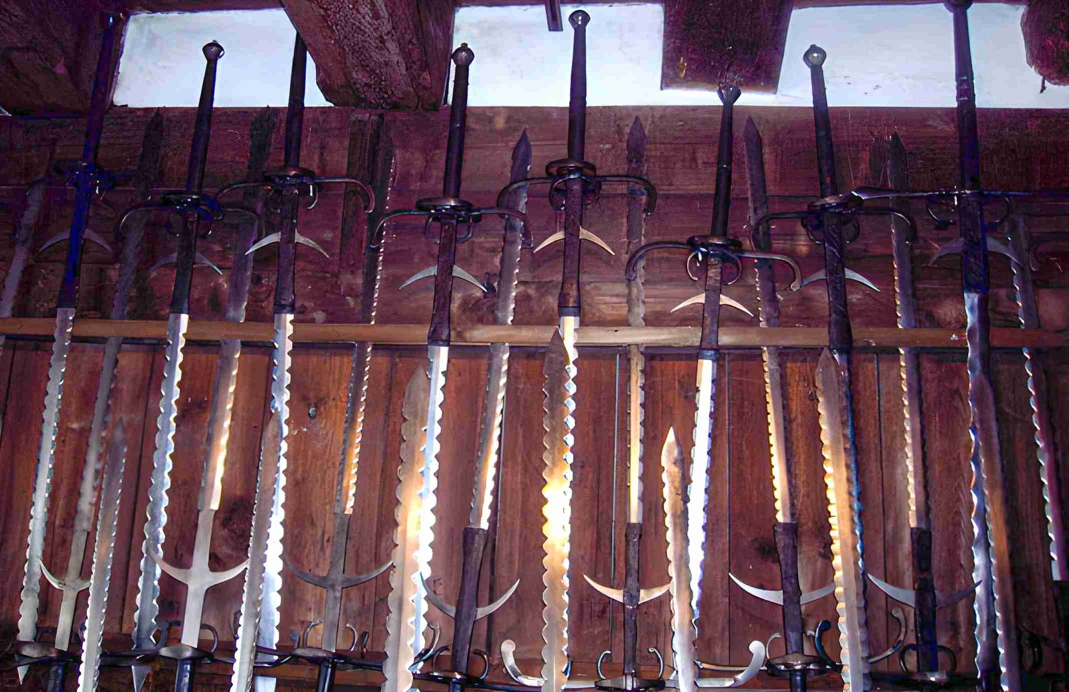 Flamberge swords on a rack.