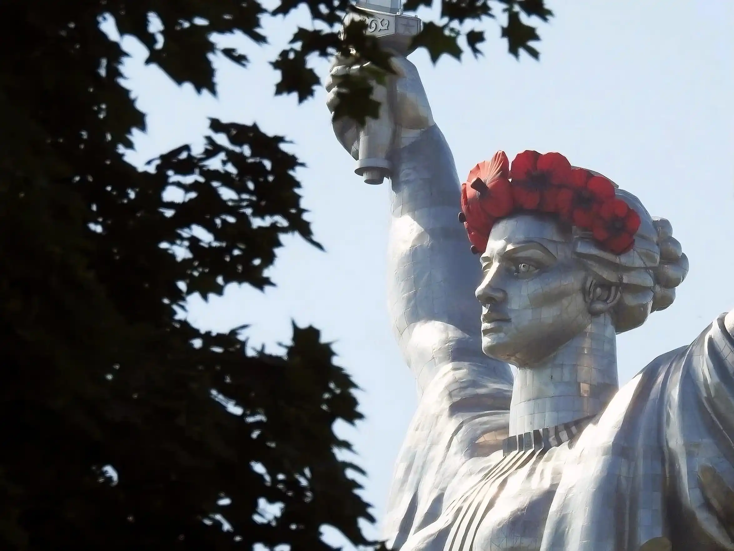 The Motherland Monument with red poppy flowers.