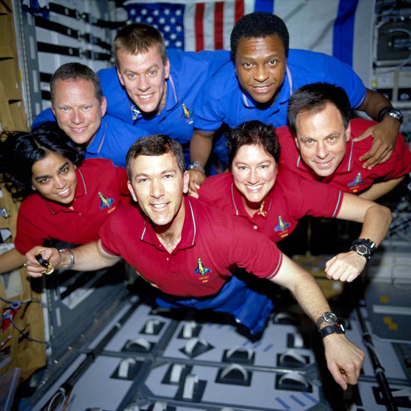 The film used to recreate this image was recovered from the Space Shuttle Columbia's debris field. The STS-107 crew shot shows the seven-member crew of the space shuttle, which was split into two teams of three astronauts each to work in 12-hour shifts. Chawla, Husband, Clark, and Ramon represent the red squad in the front row, while Brown, McCool, and Anderson represent the blue squad in the rear row.