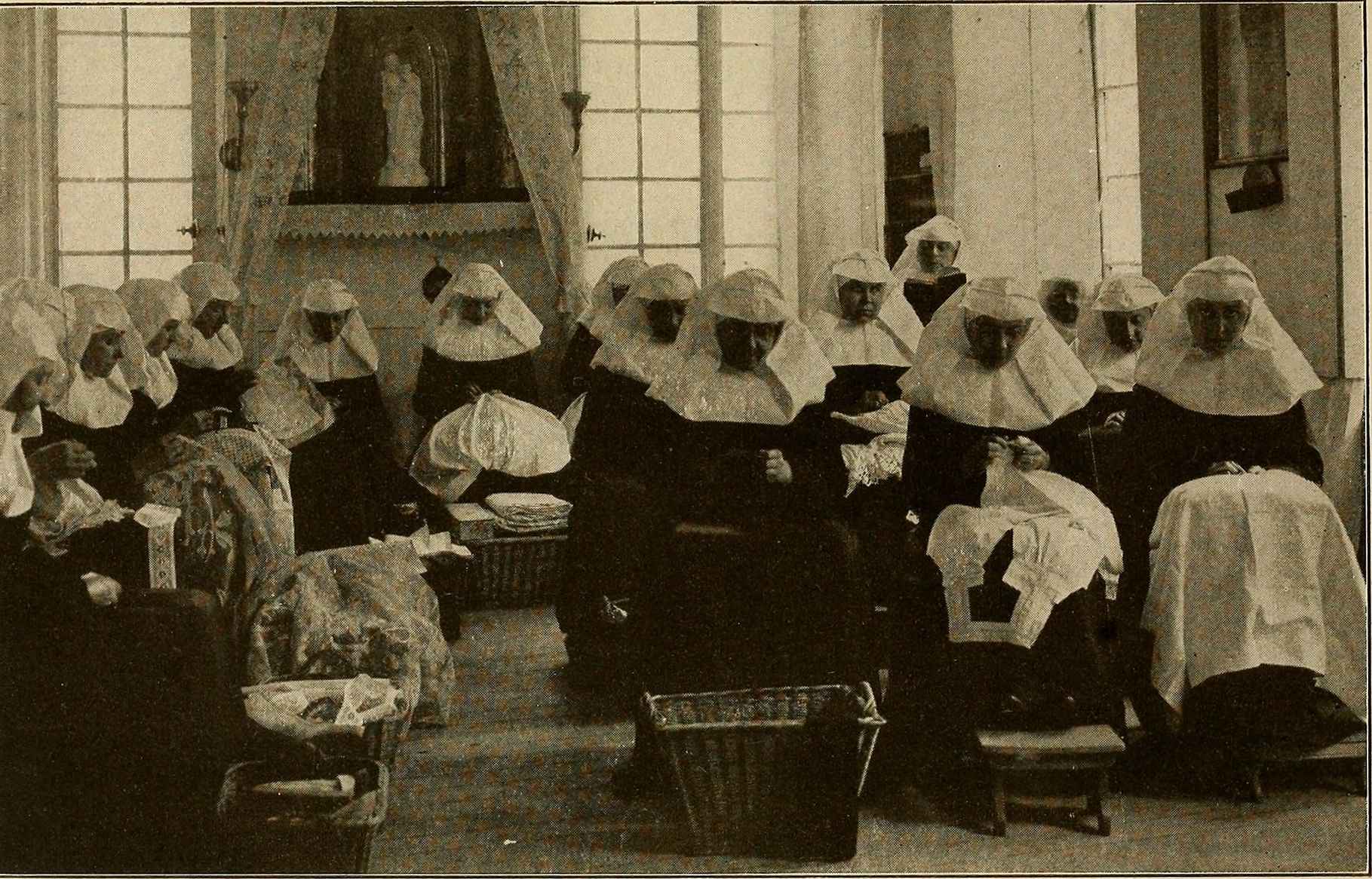 A group of beguines in the workroom of a beguinage in Ghent, Belgium, c. 1910.