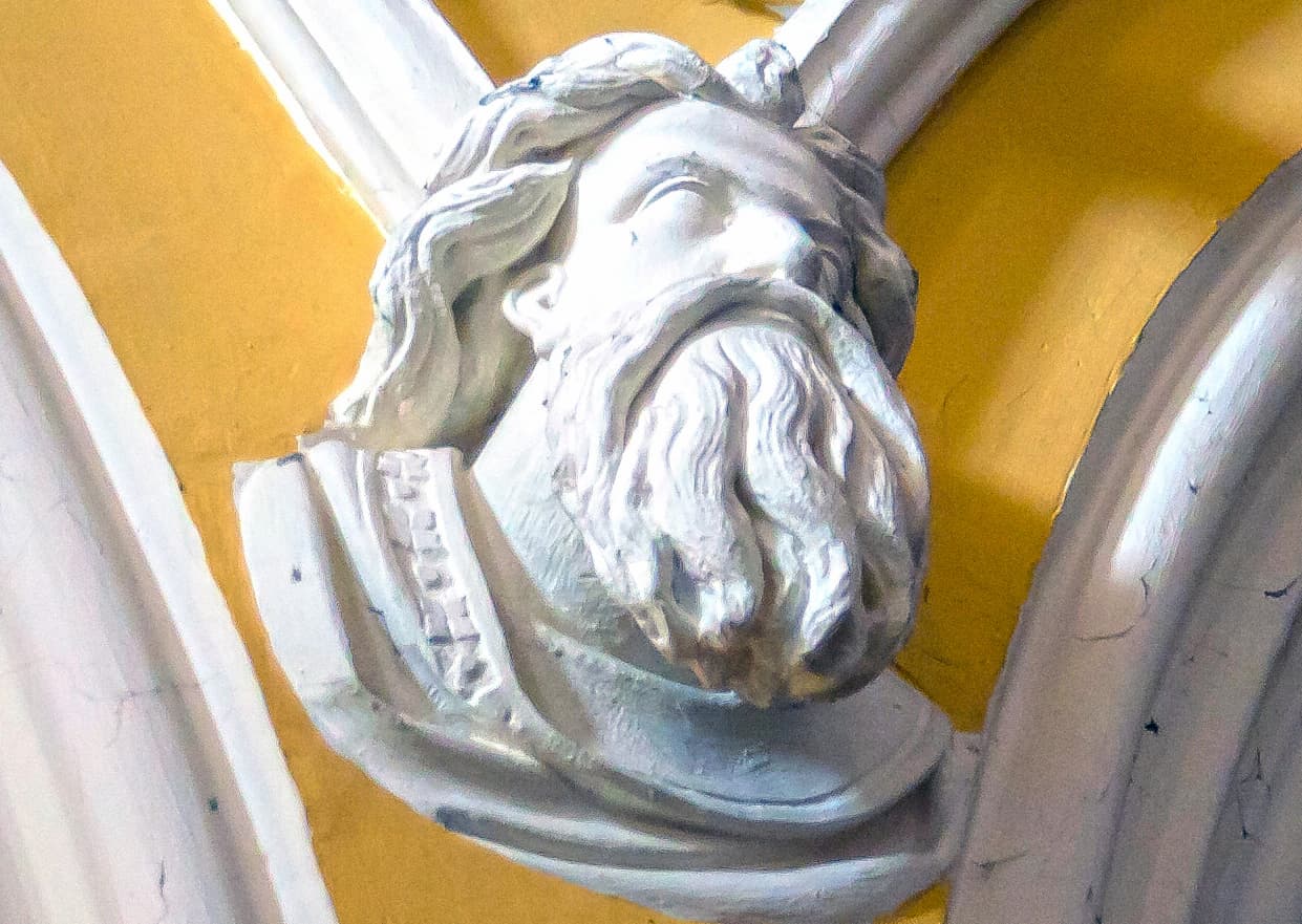 A carved head protome in a church in Ireland.