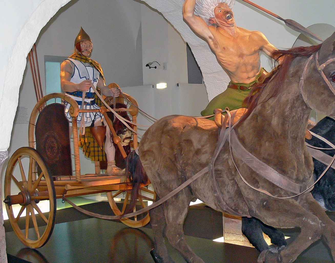 A typical Celtic chariot with a wooden wheel and a metal rim around it.