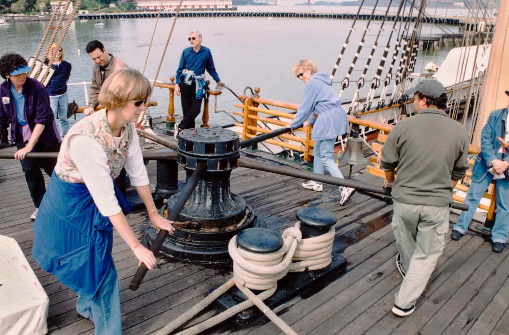 People turn a capstan with handspikes.