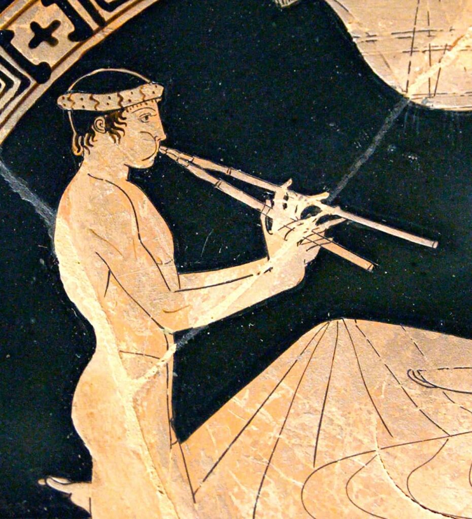 Man playing an aulos, the instrument that accompanied the dances of the Antesterias. Decoration of a dish from 460 BC, Louvre Museum.