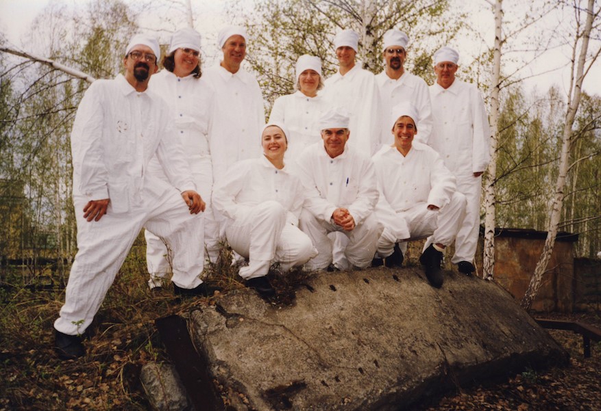 U.S and Russian scientists standing on lid from Kyshtym Disaster.
