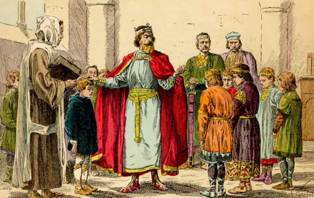 charlemagne standing next to other people, visiting a school. Lithograph in colors by E. Crété after an illustration by H. Grobet, Histoire de France, Paris, Émile Guérin, 1902.