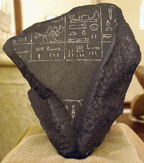 A fragment of the Palermo stone, on display at the Petrie Museum, London. It is inscribed with part of Khasekhemwy's register, and at the top with a sign from the Snefru register.